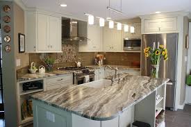 This Kitchen Features Brown Fantasy Leathered Quartzite Countertops Paired With A Glass Ti Granite Countertops Kitchen Kitchen Design Countertops Beige Kitchen