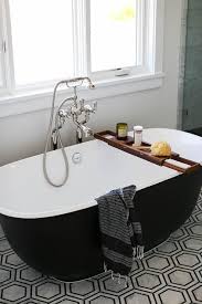 The perfect bath can make a luxurious design statement bringing comfort to any bathroom. Modern Black And Whit Bathtub With Wooden Tray Transitional Bathroom