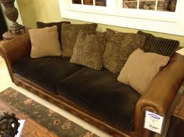 Here, a brown leather pouf sits across from the brown sofa to tie the look together. Leather Couch With Fabric Cushions Leather Couches Living Room Leather Sofa Cushions On Sofa