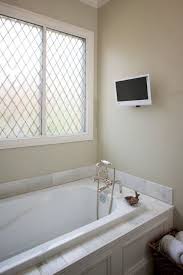 Put a tv in the bath so you can catch the news headlines you need in the morning, or watch a favorite movie while you soak in a bubble bath for the ultimate living room furniture arrangement ideas. Bathroom Tv Design Ideas