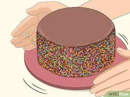 One cake has a thin crumb coat but gets covered in sprinkles so does not need to be perfect! 4 Easy Ways To Put Sprinkles On The Side Of A Cake Wikihow