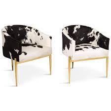 Black walls combined with black tiles and white and black print curtains give it the same old combination of white and black. Modern Art Deco Black And White Cowhide Chair Modshop