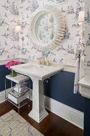 White And Navy Powder Room Features Top Half Of Walls Clad In White And Blue Ship Print Wallpape Kitchen Classic Luxury Classic White Kitchen Blue Powder Rooms