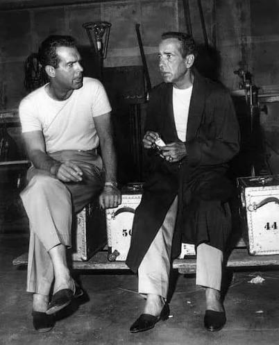 Fred MacMurray and Humphrey Bogart having a conversation behind the scenes  on the set of "The Caine Mutiny," released in theaters on this date in  1954. If you watch the film, keep