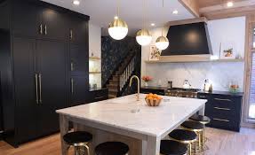 The gold bars are a smart and stylish update on trendy black shiny kitchen. One Color Fits Most Black Kitchen Cabinets