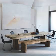 A bronzed metal base with two thick stretchers lends industrial appeal to the design. Emmerson Reclaimed Wood Dining Table