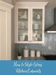 How To Style Glass Kitchen Cabinets Blue Oak Bungalow In 2020 Glass Kitchen Cabinets Glass Cabinet Decor Refacing Kitchen Cabinets
