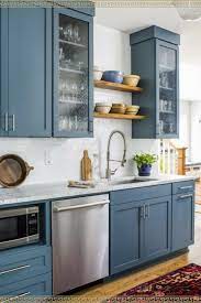 A country style kitchen design means having a relaxed and friendly kitchen space with some antique or reproduction furniture where everyone can the use of neutral colors like bone or white works well. I Love Blue Kitchen Cabinets Painted Or Maybe They Just Came That Way I Love This Modern Cou Kitchen Design Country Cottage Kitchen Blue Kitchen Cabinets