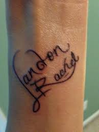 Heart tattoos with names on wrist. Pin By Erika Ziner On Tattoos Name Tattoos For Moms Wrist Tattoos For Women Cool Wrist Tattoos