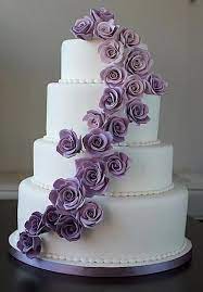 White Wedding Cake With Purple Roses Purple Wedding Cakes Wedding Cake Roses White Wedding Cake