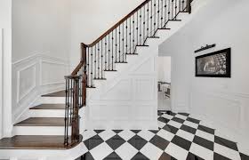 Featuring a mottled finish and muted color palette, these tiles recreate a classic look with the durability and versatility of a modern tile. Cancos Tile Stone Featured In This Stunning Black And White Entryway Graphic Patterns Create A Beautiful D White Foyer White Porcelain Tile Staircase Design