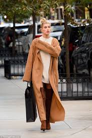 I'm finally getting around to post my favorite outfit from new york fashion week. Hailey Baldwin Wears Over The Knee Suede Boots And A Flowing Camel Coat In New York Daily Mail Online