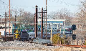 CSX Trenton Line double stacker passing the SEPTA station at Yardley,  Pennsylvania