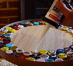 I had a coffee table in and because the table was not perfectly flat, they began to drift to one side of the table. Diy Beer Bottle Cap Table