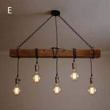 This is a unique example of farmhouse lighting and quite creative in its execution. Handmade Rustic Wooden Chandelier Wood Beam Industrial Pendant Lamp Wooden Chandelier Wooden Pendant Lighting Rustic Chandelier