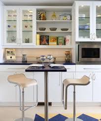 The translucent, full door glass layered panels and interior lighting takes the edge off of the darkness. Decorating With Glass Cabinets Doors Brings Light Into Modern Kitchen Designs