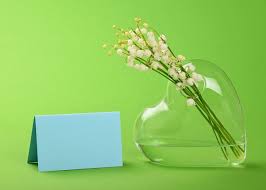 Bunch Of Lily Of The Valley Convallaria Majalis Flowers In Heart Glass Vase With Blue Card On Green Flower He Holiday Templates Love Massage Valentine Poster