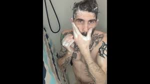 Sexy tattoo man taking shower