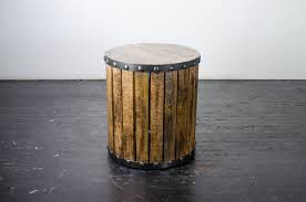 The table's clean lines reflect meticulous attention to detail and artisanal craftsmanship. Side Table Industrial Plank Wood Drum Amigo Party Rentals Inc