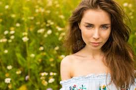 Photo of Pretty Brunette Woman in Chamomile Field Stock Image