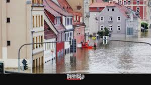 .in germany after heavy flooding turned streams and streets into raging torrents, sweeping away cars a firefighter wades through a street in kordel, germany, which was flooded by the kyll river. Crthy11etbokmm