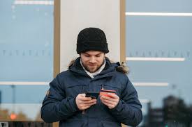 Offer includes the everyday 5% off j.jill credit card discount. Cheerful Man Entering Details Of Credit Card On Smartphone On Street Free Stock Photo