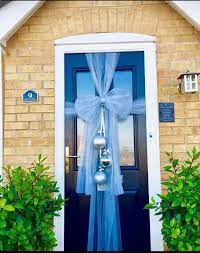 christmas door bow grey with silver baubles l also put lights on it it looks fabulous at night door bows christmas front door christmas bows door bow