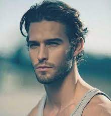 Hairstyles For Shoulder Length Hair Man With Brushed Back Curly Hair Stubble Beard And Mustache Mens Hairstyles Medium Medium Hair Styles Thick Hair Styles