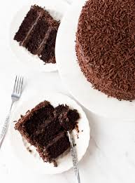 Soft chocolate cake roll filled with light and fluffy frosting with folded mini marshmallows, drizzled with chocolate syrup and topped with more marshmallows. Brigadeiro Cake Recipe Brazilian Kitchen Abroad