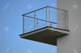 This post contains affiliate links for your convenience. One Balcony With Glass Railing Against Blue Sky On Sunny Day Stock Photo Picture And Royalty Free Image Image 129173007