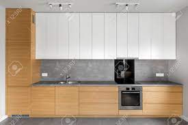 Light grey kitchen with wood worktop ukg pro. Grey Kitchen With Wooden Cabinets Granite Worktop And White Cupboards Stock Photo Picture And Royalty Free Image Image 75442441