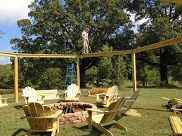 Make sure you've got a wide open area away from tall grass and low hanging trees. Remodelaholic Tutorial Build An Amazing Diy Fire Pit Pergola For Swings