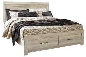 Modern styled panel bed with 2 storage drawers located in headboard, footboard, platform rails, roll slats, dresser, mirror, chest, night stand. Bellaby King Platform Bed With 2 Storage Drawers With Dresser Ashley Furniture Homestore