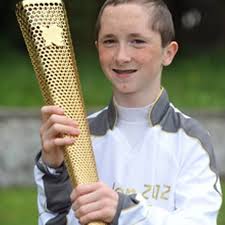 Joy for celebral palsy sufferer Conor McAdam, 14, as he carries the Olympic  torch