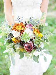 A romantic wedding bouquet of peachy peonies and white ranunculus, succulents and greenery is a cool and fresh idea to rock. Natural Succulent Wedding Bouquets