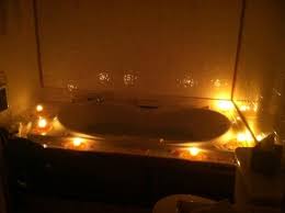 Young woman relaxing in the hot tub. Candles And Flower Petals Around Tub In Original Log Cabin Picture Of Donna S Premier Lodging Berlin Tripadvisor