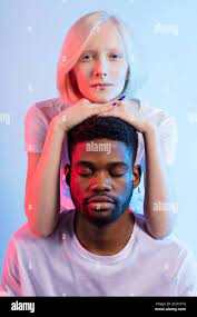 awesome young interracial couple doing yoga,the strength of hypnosis ,  health , body care concepts, close up photo, isolated blue background,  studio s Stock Photo - Alamy