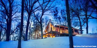 Snow covered log cabins in the woods in a forest. 6 Cabins For Romantic Winter Getaways
