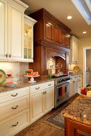 Traditional Kitchen With Contrasting Island And Hood Antique White Kitchen Brown Kitchen Cabinets Brown Granite Countertops