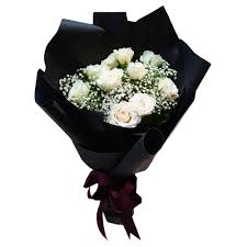 Beautiful spring flowers on the white table, selective focus. White Roses Black Wrap Bouquet Flowers By Jack Koh Samui Florist