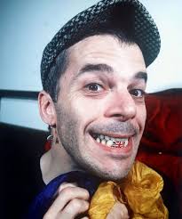 THE UNDERESTIMATOR — Ian Dury flashing a Union Jack grin to the press...