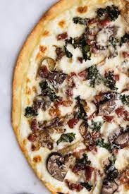 White Sauce Pizza With Prosciutto Caramelized Onions Kale And Mushrooms Recipe White Pizza Sauce White Sauce Recipes White Pizza Recipes