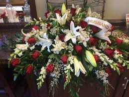 Funeral flower arrangements can come in many shapes and styles. Red And White Casket Spray Casket Flowers Memorial Flowers Funeral Flower Arrangements