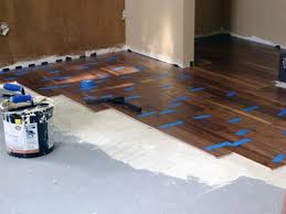 Diy Hardwood Flooring Part 3 Gluing Those Babies Down I Will Say This These Floors Are A Litt Installing Hardwood Floors Diy Hardwood Floors Diy Flooring