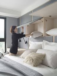 If that sounds good to you, putting a tv in the bedroom could be a smart move. A Comfy Bed With Felt Covered Cabinets Over The Bed To Accomodate Various Things Small Space Bedroom Small Bedroom Storage Diy Bedroom Storage