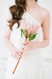 With these single stem fabric ruffle flowers, your wedding bouquet can now last forever! Single Protea Bouquet Photo By Blush Wedding Photography Http Ruffledblog Com Modern Tropi Tropical Wedding Inspiration Single Flower Bouquet Protea Bouquet
