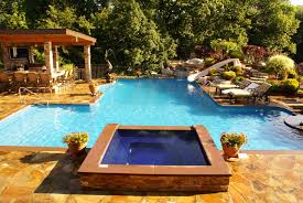 Pool Accessories To Put At The Top Of Your Holiday List Swim Up Bar Hot Tub Spa Geometric Shaped Pool Relaxing Backyard Rectangular Pool Pool Designs