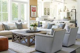 The whole design is wrapped in brushed polyester linen upholstery, accented by piped edges and gleaming silver nailhead trim, while cushioned padding provides comfortable support. Rectangular Wooden Coffee Table With Metal Trim Transitional Living Room
