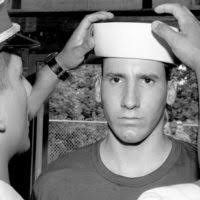 Midshipman 1ST Class Jeri Smalley inspects the uniform of Midshipman  Candidate Gary Sussman during the first day of his indoctrination period at  the Naval Academy Preparatory School