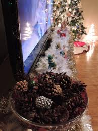 Pinecones Tinsel Battery Candles And Other Christmas Decorations On Tv Stand Tv Stand Christmas Decor Xmas Decorations Christmas Decorations